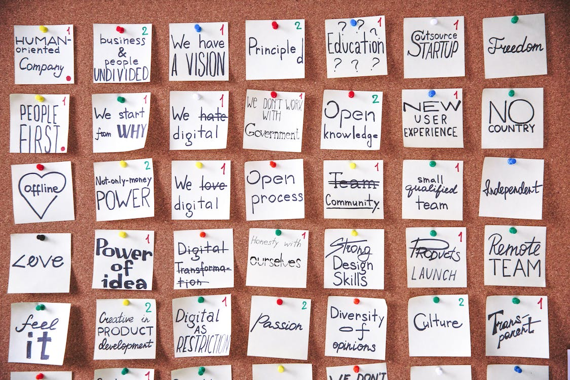 a pinboard with motivational messages written on notes