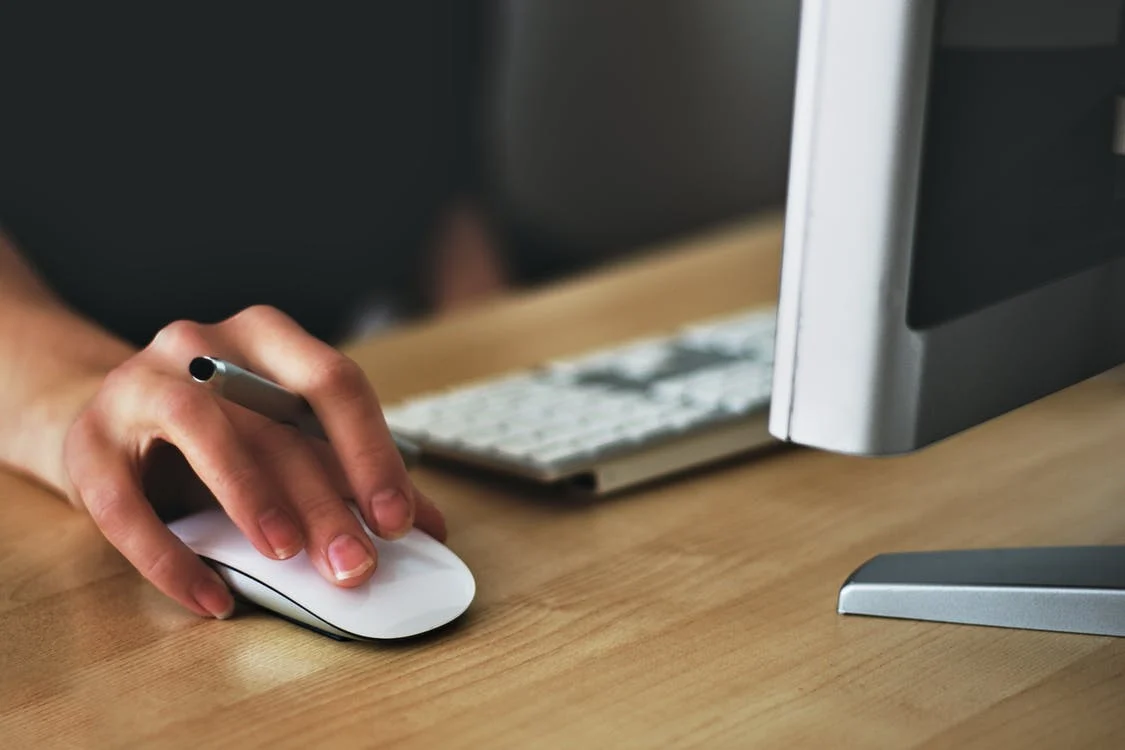 hand on mouse holding pen working