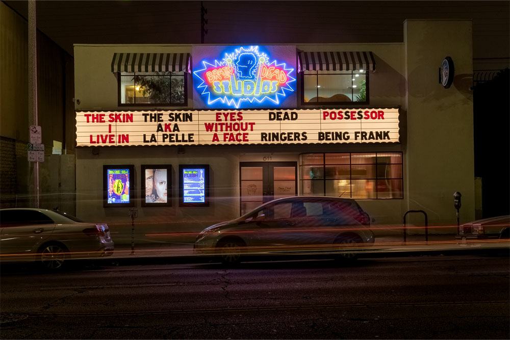 photo of the front of brain dead studios with lights on