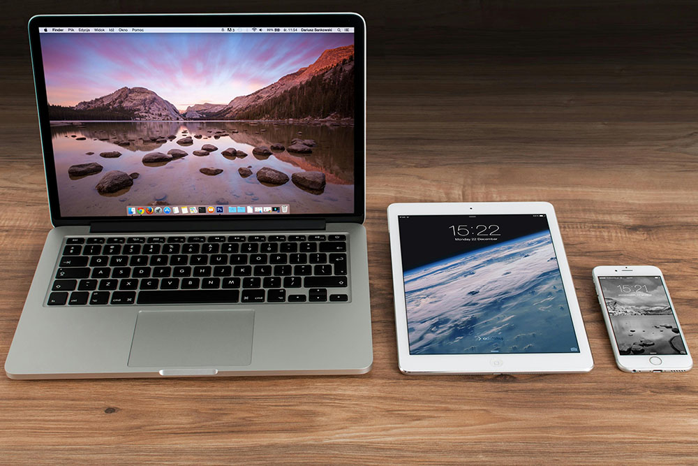 three apple devices on a desk macbpook pro ipad and iphone for how do you build a website