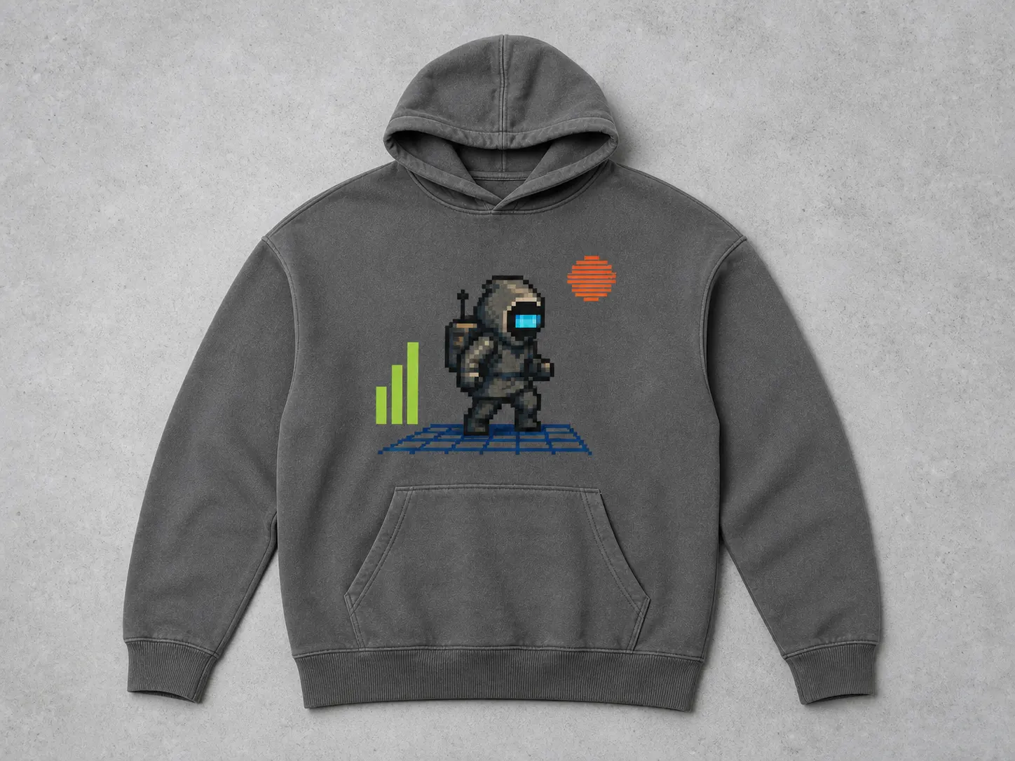 Gray hoodie with pixel art of a futuristic figure, green bars, and orange sun, on a textured gray background.