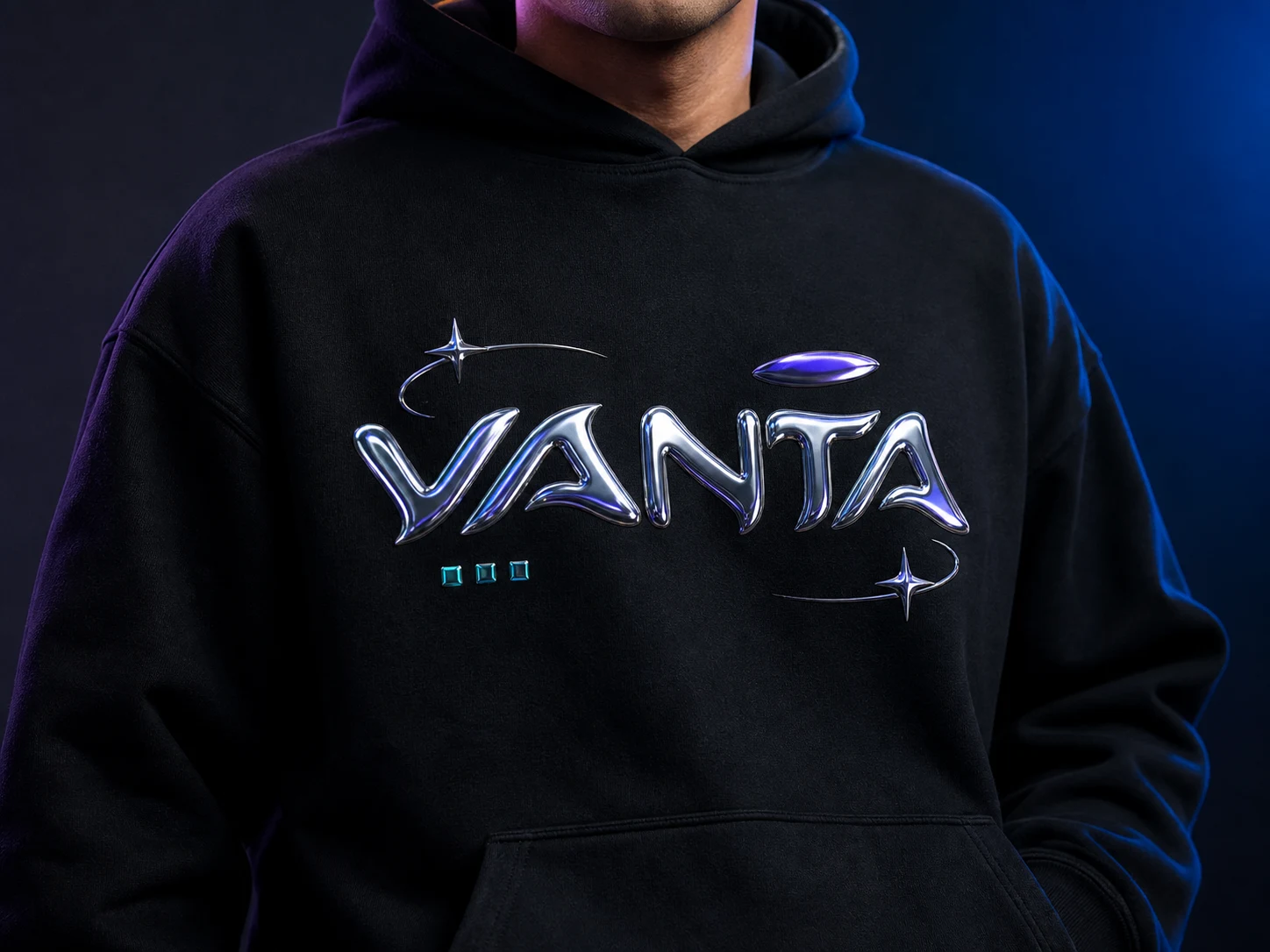 Person wearing a black hoodie with "VANTA" in shiny, metallic letters, set against a dark, blue-lit background.