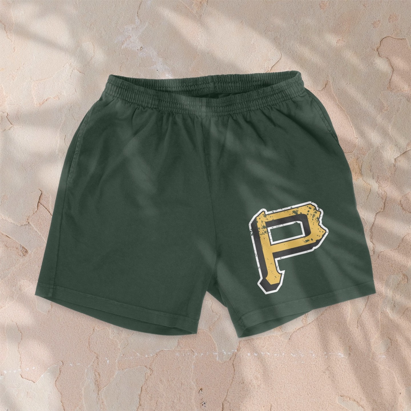 Green shorts with white, red, yellow 'P' logo, pocket.