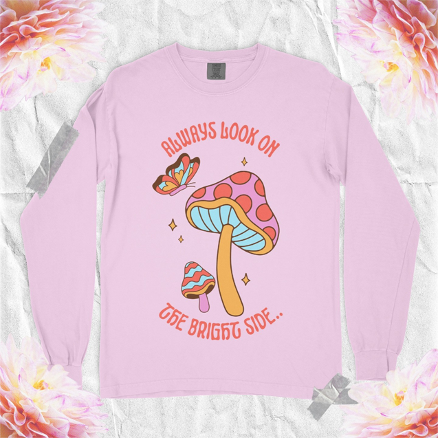Pink long-sleeve shirt with mushroom illustration and quote.